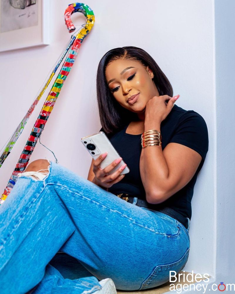 Minnie Dlamini is looking at her phone