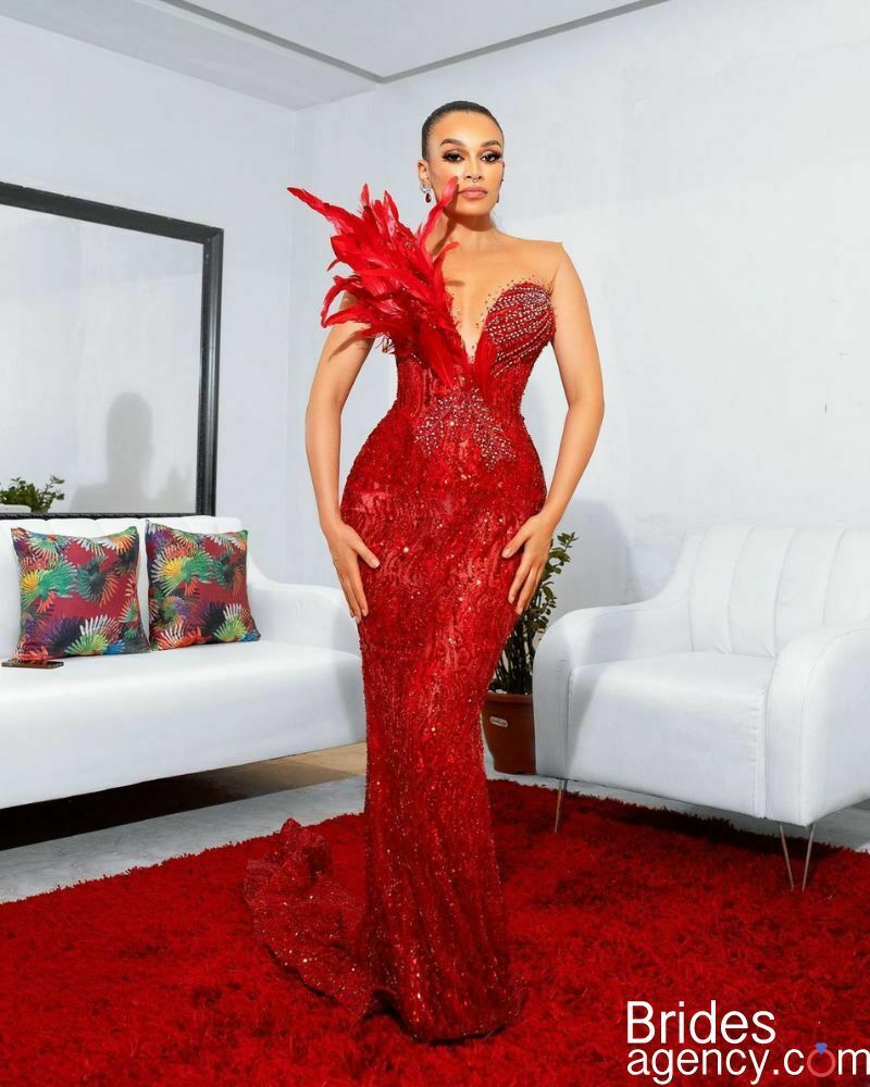Pearl Thusi in a bright red dress