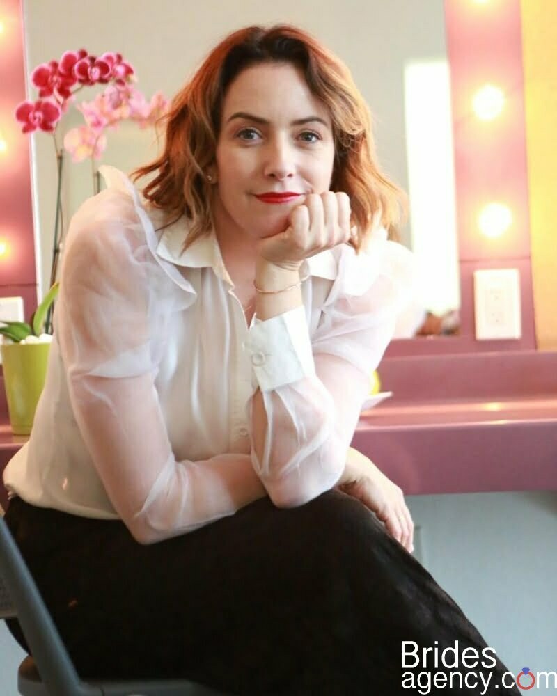 Alondra de la Parra smiling in a white shirt